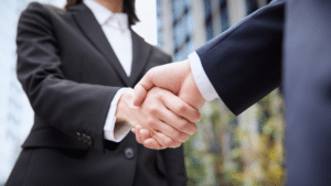 deux professionnel se serrent la main Gest'in carte G et externalisation